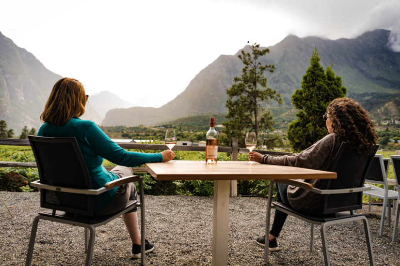 Two people enjoying a glass of wine and the view at Fort Berens Estate Winery | Eco Escape Travel